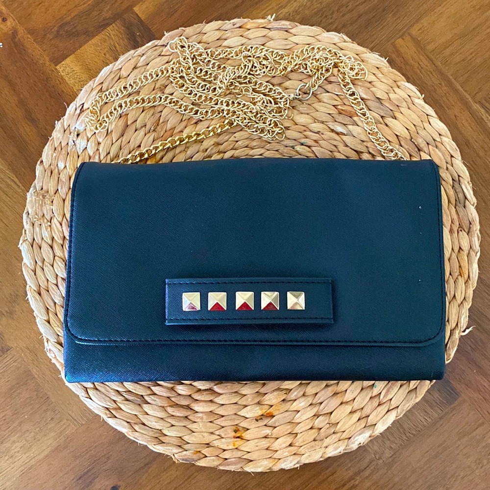 Black and gold studded cross body bag/clutch with removable chain.